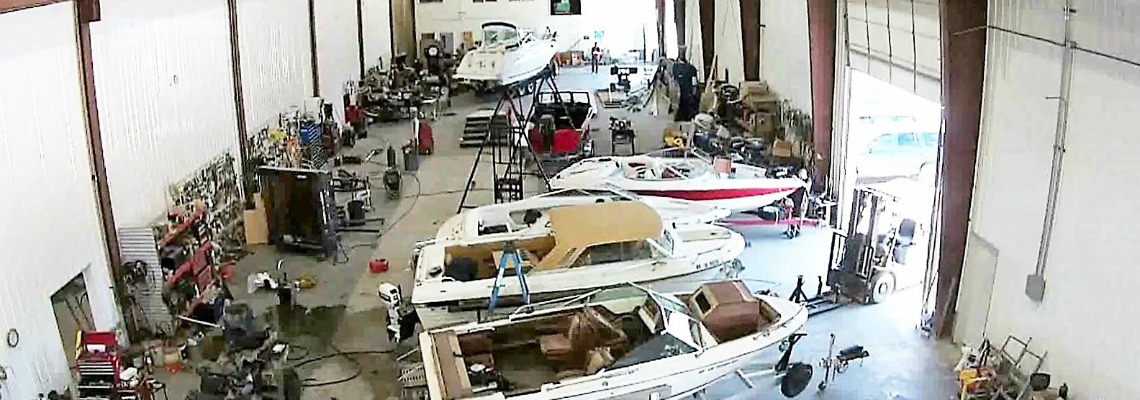 Various boats stationed in a service garage.